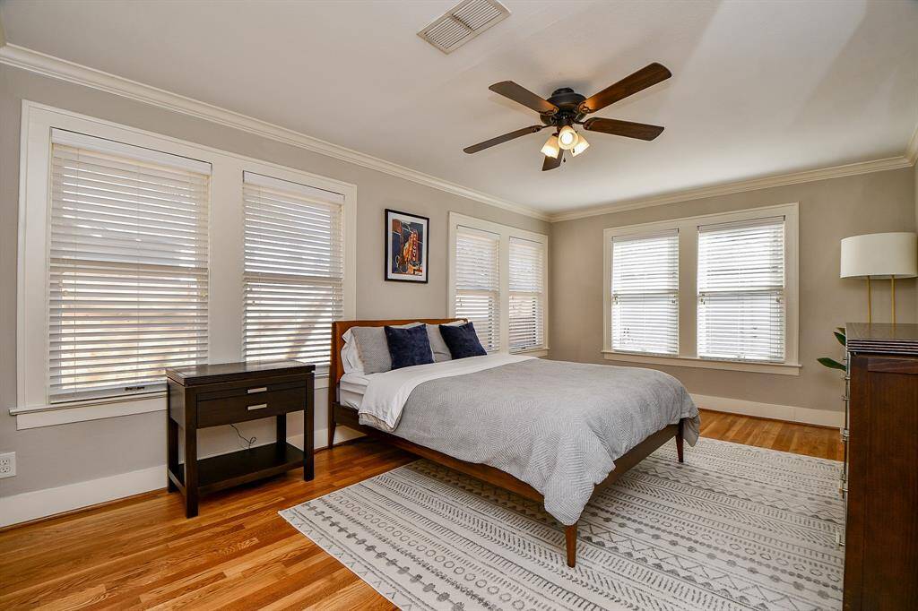 The primary bedroom is spacious and has room for a sitting area. Look at the beautiful windows!