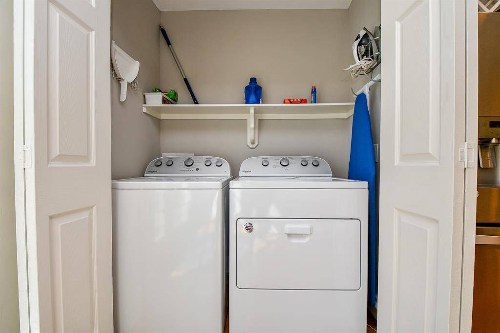 The washer and dryer are hidden in the kitchen.