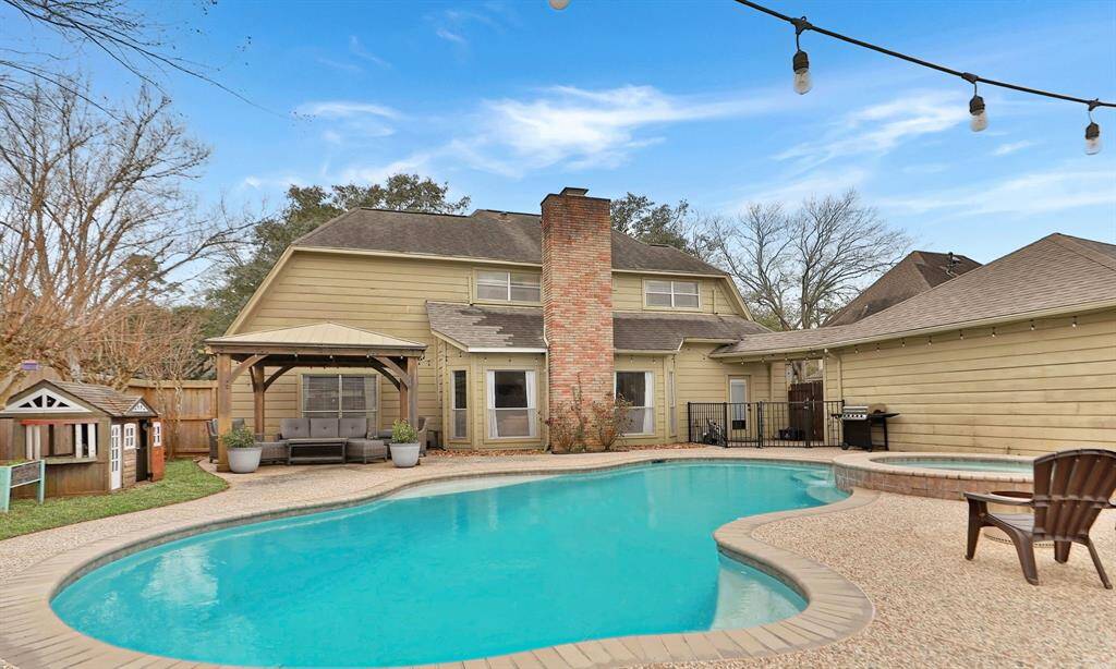 The home's exterior is charming with a classic brick chimney and safety fence from the back door to the pool area - helping to protect children and animals from the pool.
