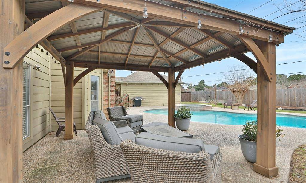 A charming pergola overlooks the sparkling pool.