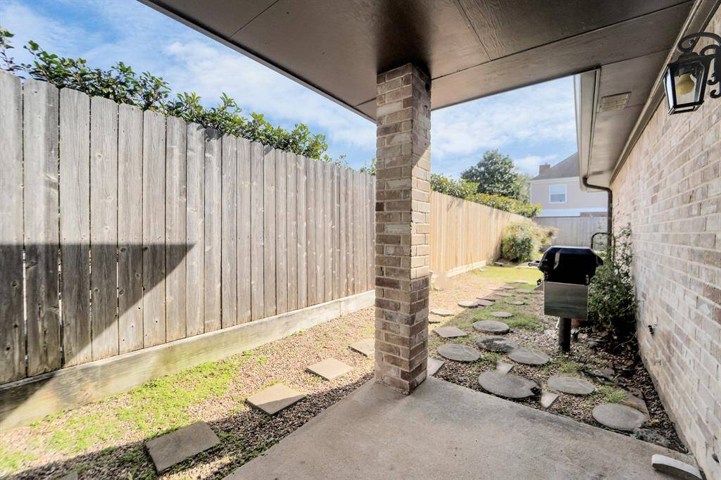 Covered patio with built in gas grilling station located outside of the breakfast room.