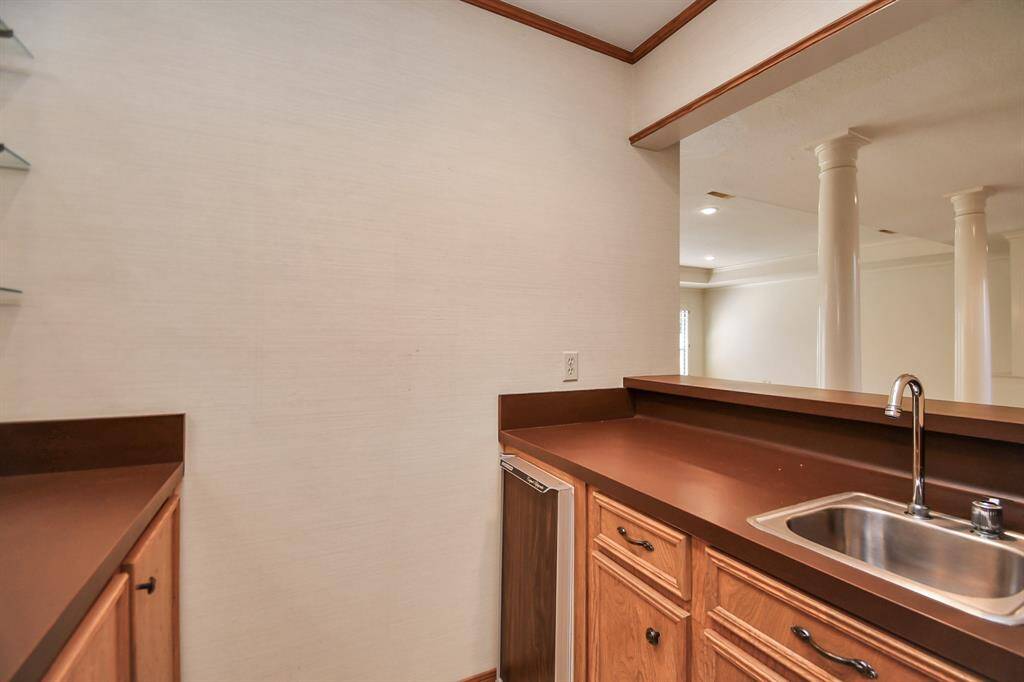 Wet bar makes entertaining a snap, but could also flex as wine room, coffee bar or enclosed storage closet.