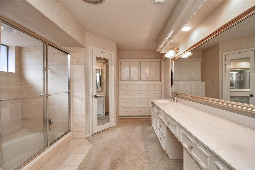 One of the most popular features of many classic Sugar Creek homes is the wall of built-in drawers in the primary bath. The storage in this home is unbelievable!