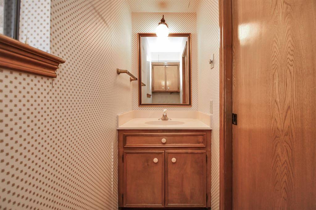 Powder bath overlooks covered patio and is tucked away off of laundry room.