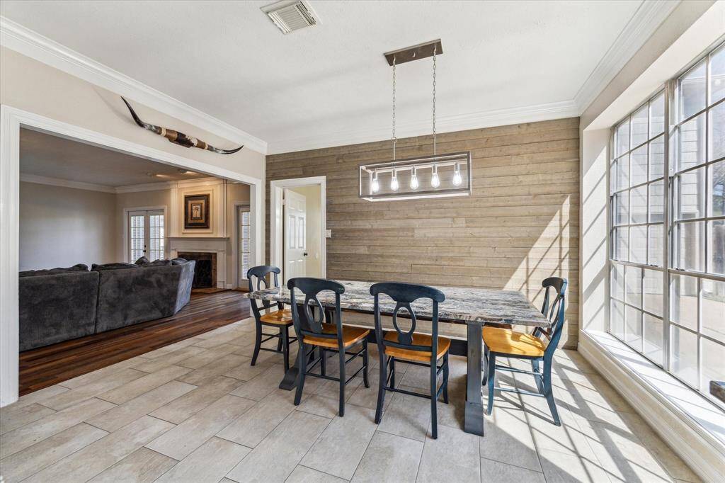 The charming breakfast area offers a perfect spot to start your day, featuring a granite-topped table that stays with the home and beautifully matches the kitchen countertops for a seamless design. Large windows fill the space with natural light, creating a warm and welcoming atmosphere. Ideal for casual dining or morning coffee with a view!