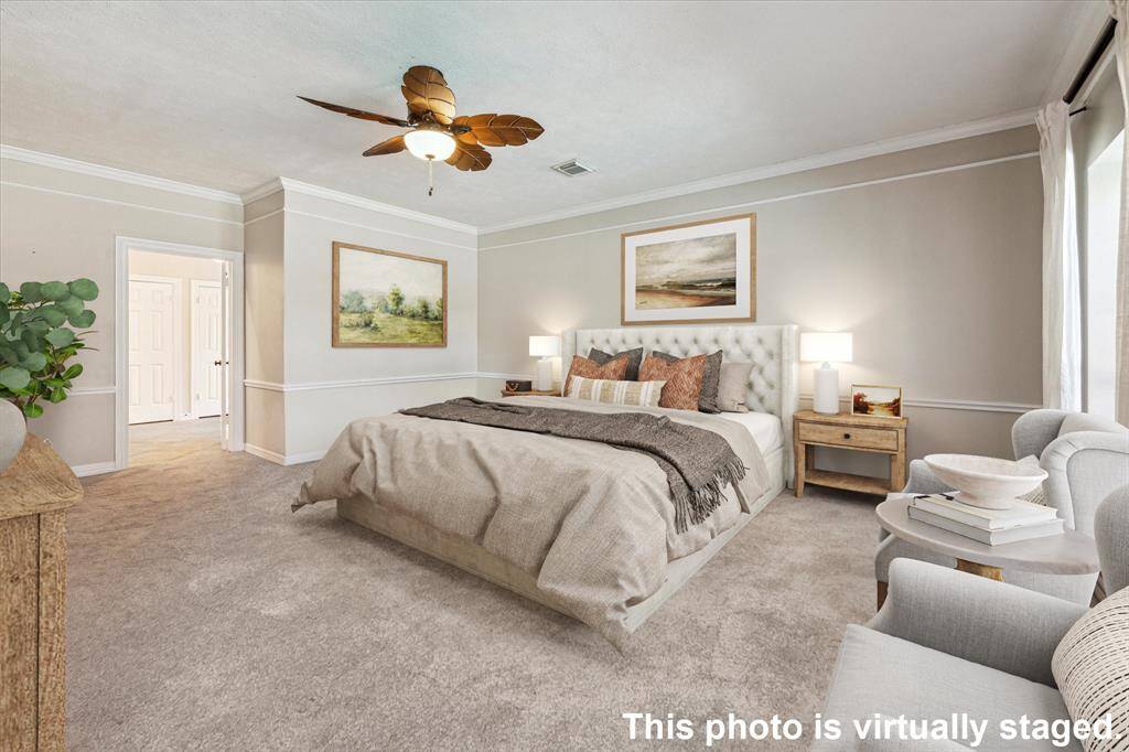 The primary bedroom features beautiful crown molding and chair rail accents. Direct access to the en-suite bathroom enhances convenience, making this suite both stylish and functional!