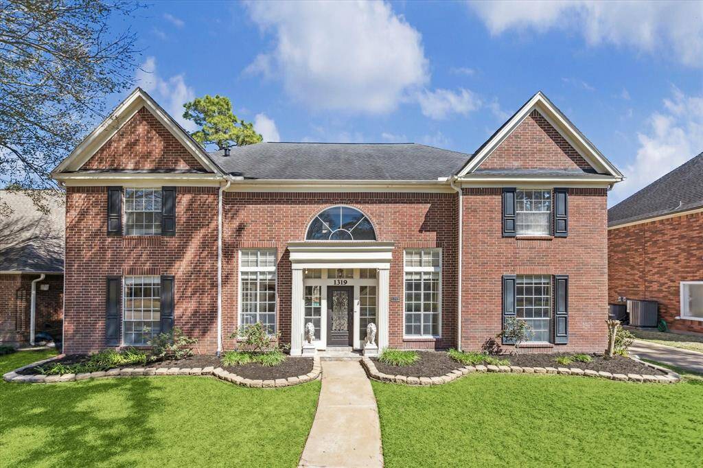 This stunning two-story home in Pin Oak Village boasts classic curb appeal with a timeless red brick exterior, elegant columns, and a grand arched entryway. Manicured landscaping and charming architectural details enhance its stately presence, welcoming you home to comfort and sophistication.