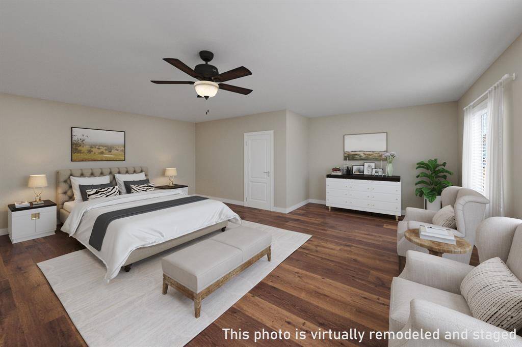 This photo has been virtually remodeled and staged to showcase the 6th bedroom’s potential. Currently, the owners use this space as a Tiki room and bar, featuring a bar area with mini-fridge and a sink along the back wall where the bed is shown in the image. This setup offers the possibility of a private retreat with a mini-kitchen. Before closing, all Tiki décor, wall, and ceiling coverings will be removed, and the walls will be restored to a standard bedroom finish.