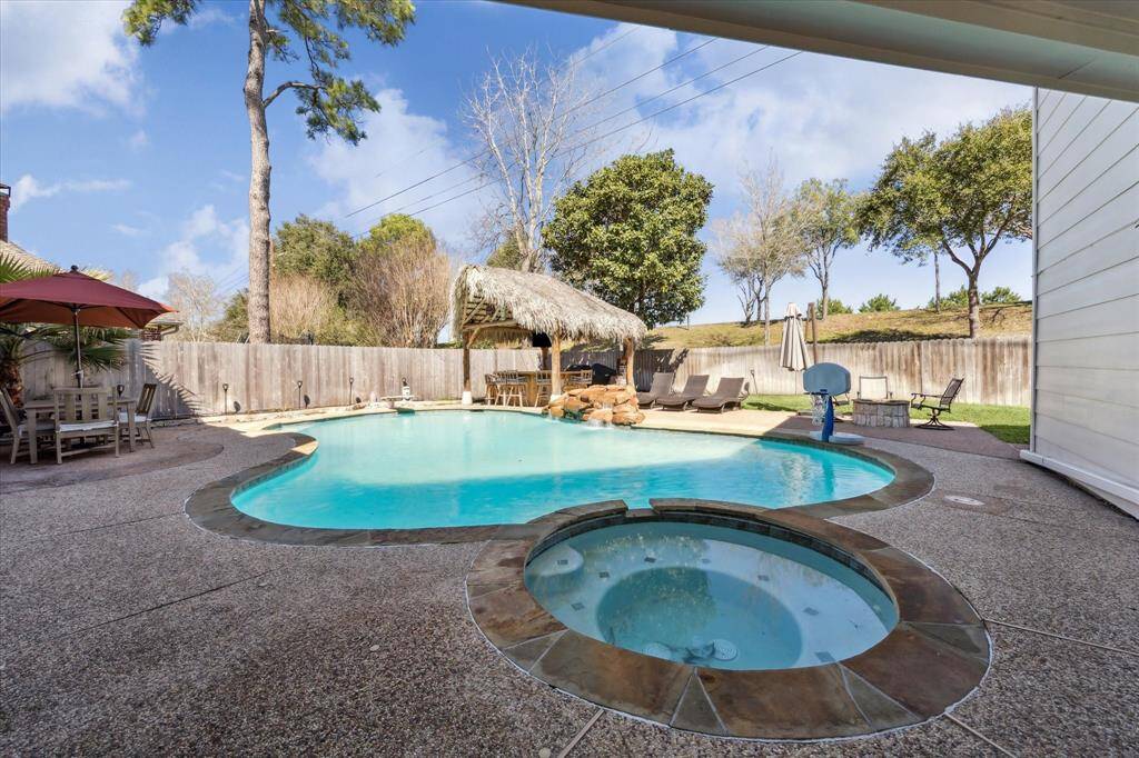 Step outside to a relaxing view of the pool and spa area.  The pool was re