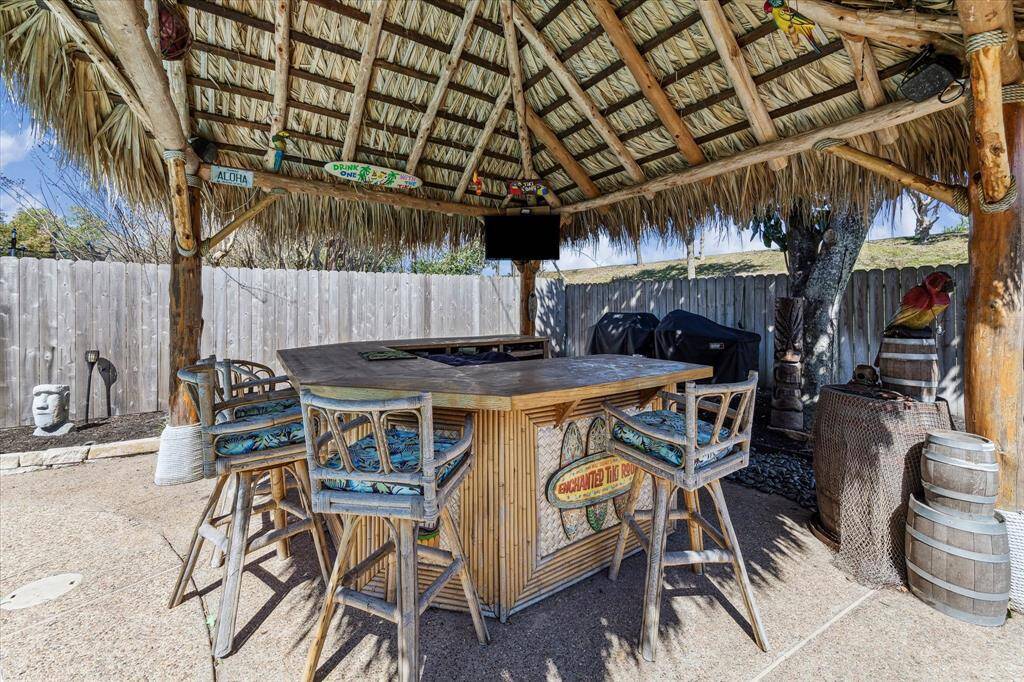 Perfect for entertaining is this backyard custom designed palapa and bar area.
