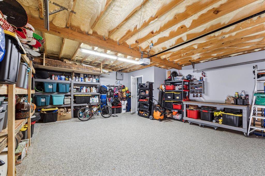 Epoxy garage flooring resurfaced in 2020 and the garage has been structurally reinforced. Inside the garage is the second half bath - a great addition for those wet bodies exiting the pool!