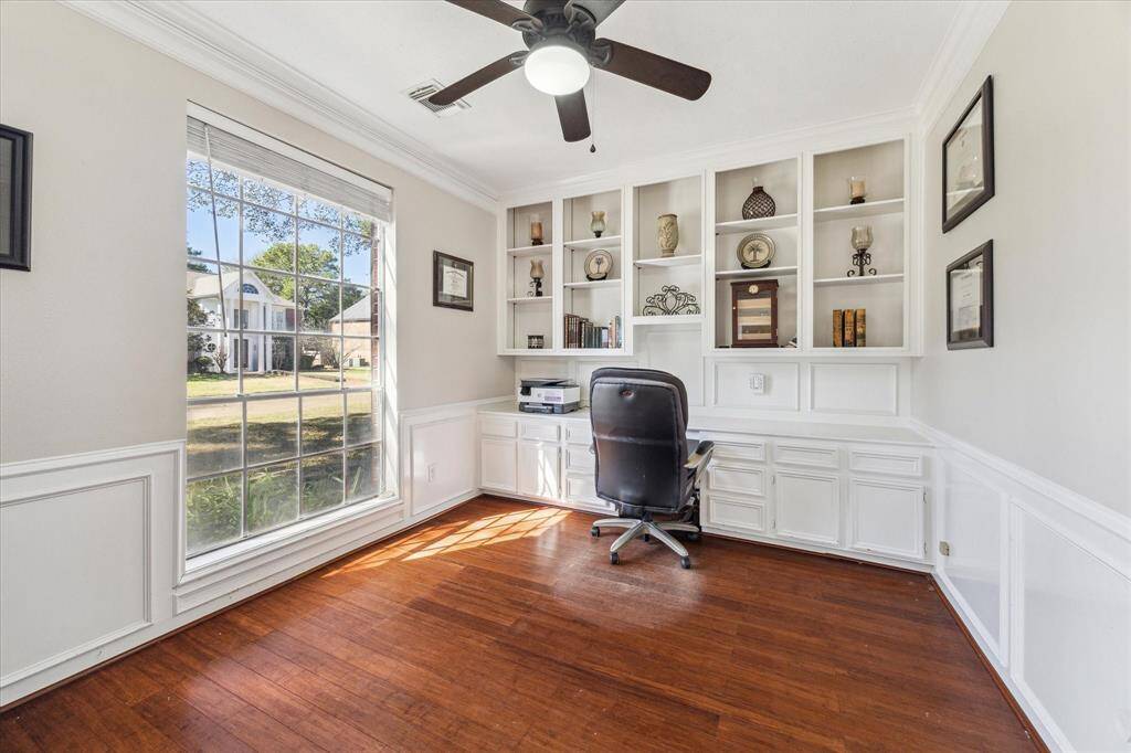 Work from home in style with this beautifully designed office space featuring custom built-in shelving, elegant wainscoting, and beautiful floors. A large, front facing, picture window fills the room with natural light, creating a bright and inspiring atmosphere. Whether used as a study, library, or creative space, this office offers both functionality and charm!