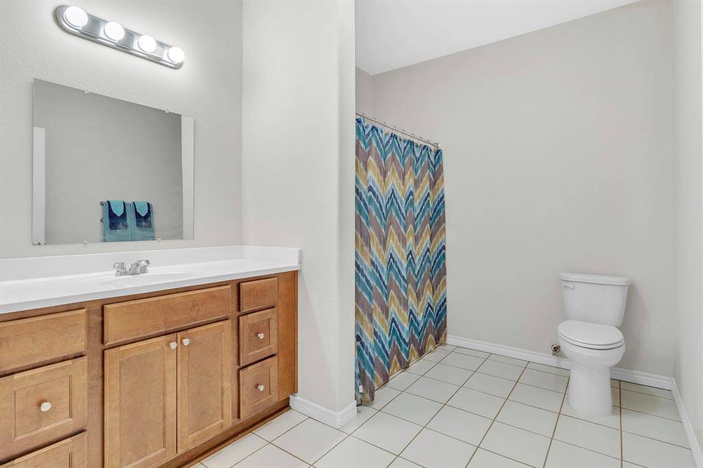 Expansive guest bathroom with a generous vanity.