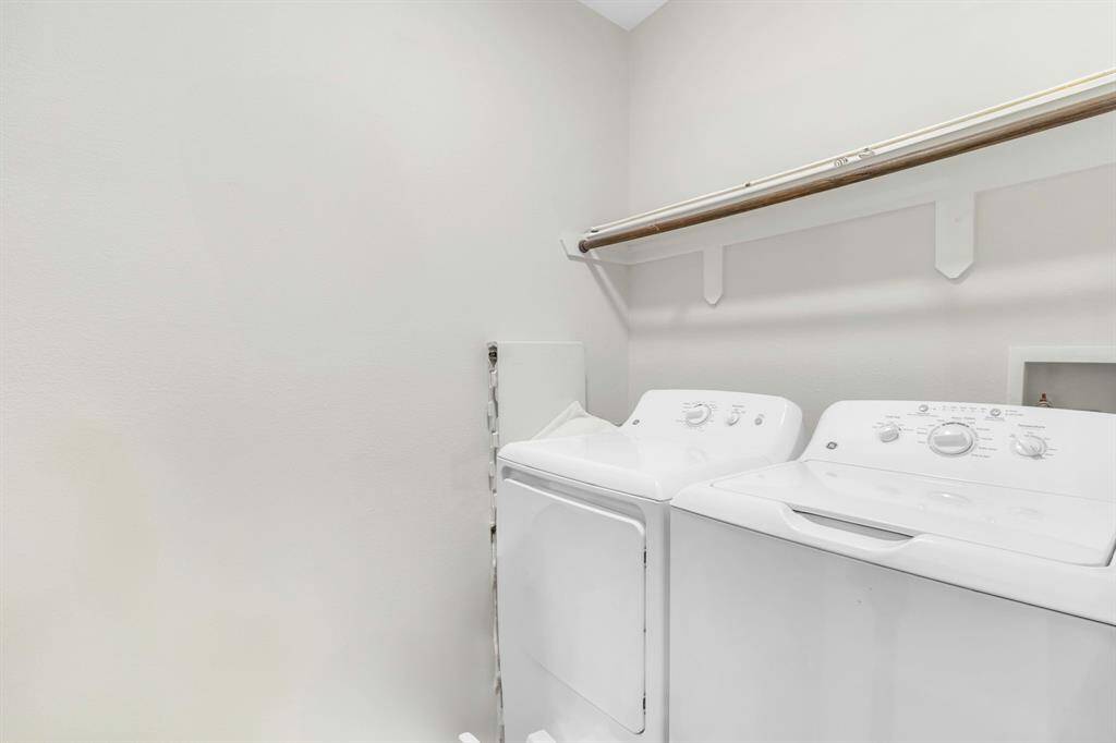 Convenient utility room with washer and dryer hookups, located right off the kitchen.