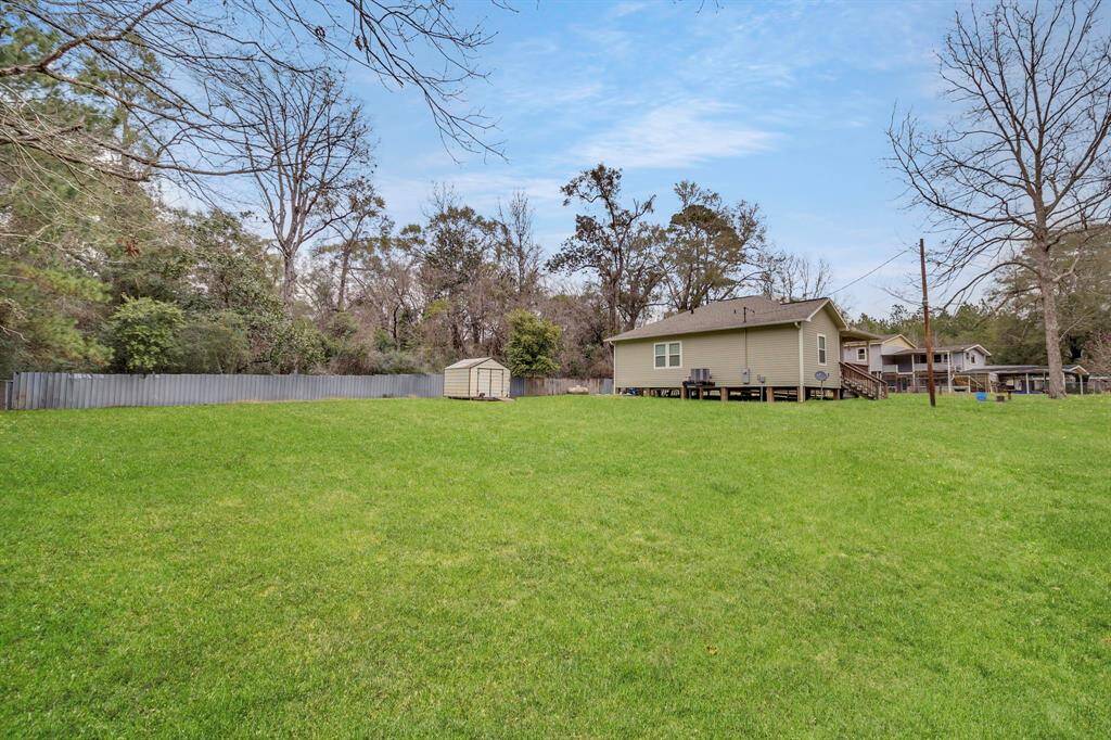 Expansive, fully fenced lot with convenient storage shed.