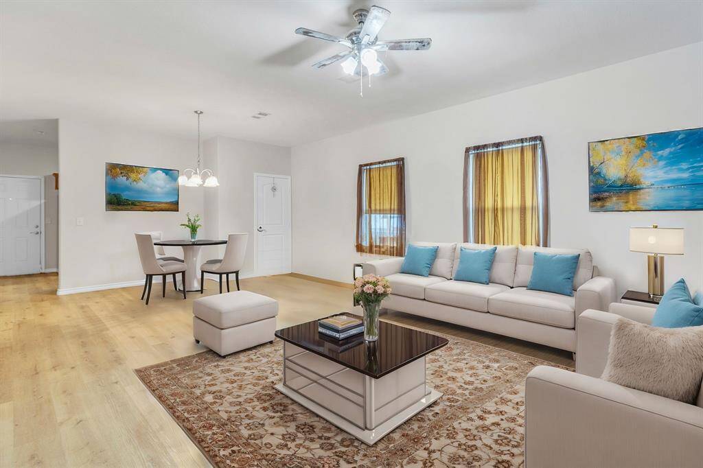 Inviting and spacious, this virtually staged living-dining area offers a perfect blend of comfort and style.