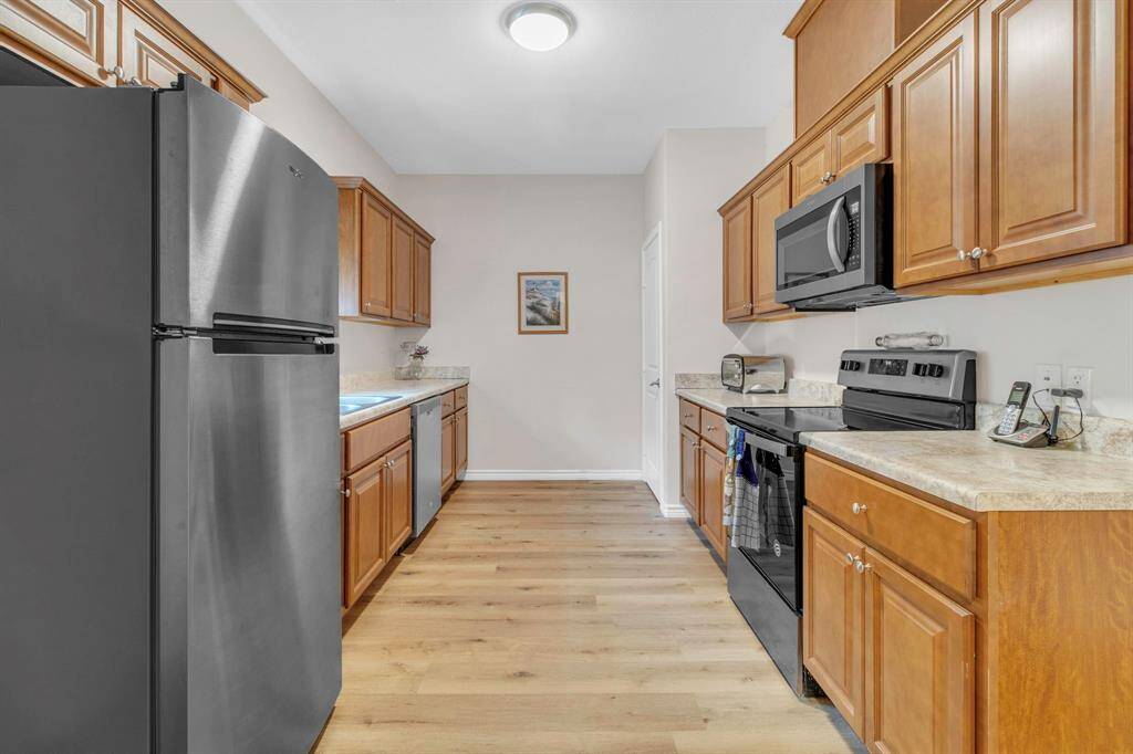 Modern kitchen with ample storage, pantry, and sleek electric range.