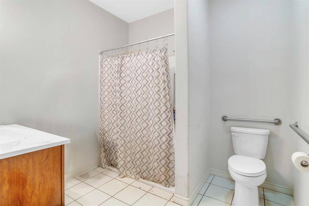 Accessible primary bathroom with a convenient roll-in shower.