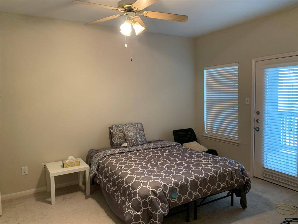 Spacious bedroom with access to the outdoor patio.  It also has a large walk in closet lots of storage.