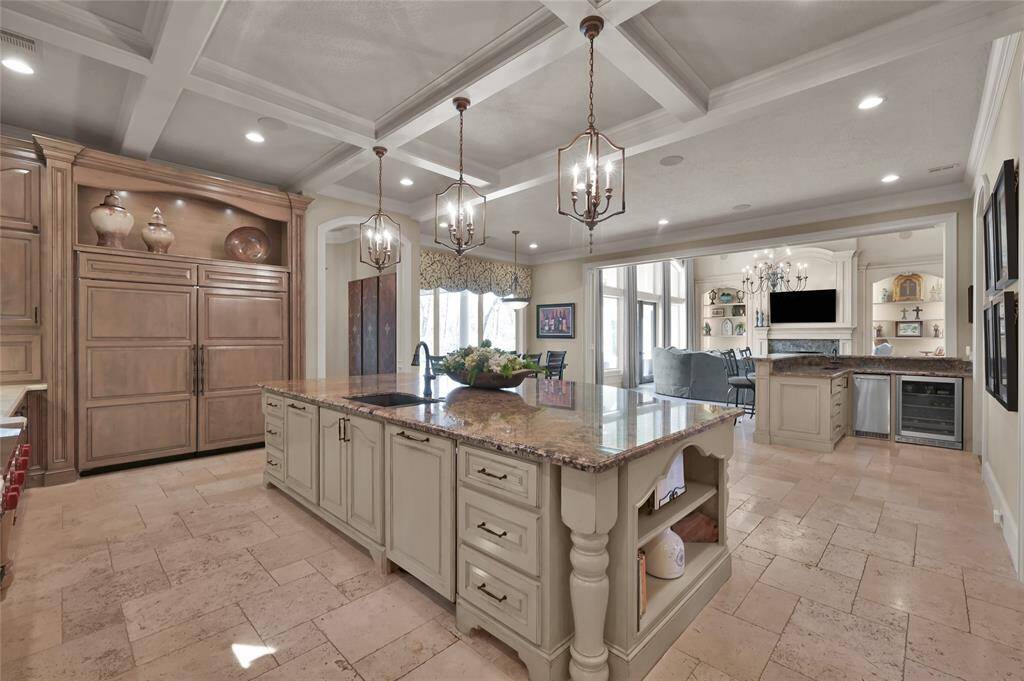 The Chef's kitchen features a Sub-Zero cabinet front refrigerator/freezer and an oversized island.