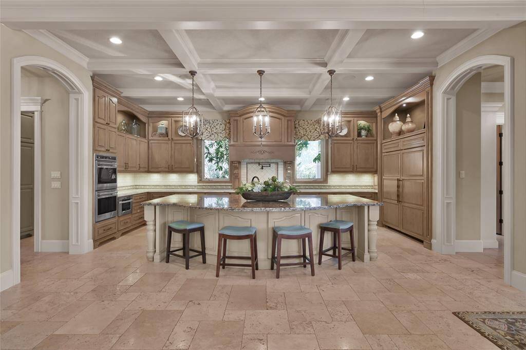 Under island cabinets, extensive counters with under mounted lighting and electrical outlets plus double-tiered upper cabinets offers amazing storage.