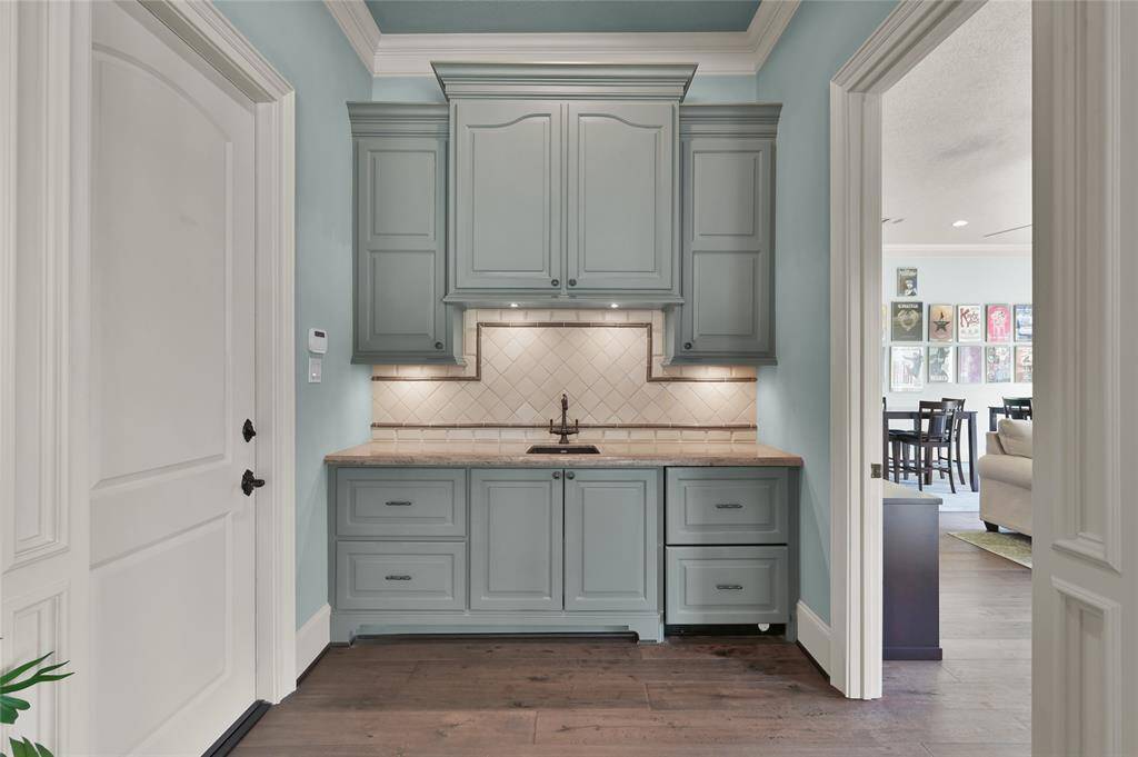A small wet bar with sink, fridge and cabinets offer extra convenience.