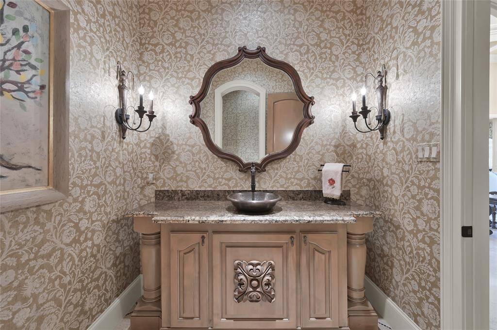 One of two half baths is elegant and classically appointed.