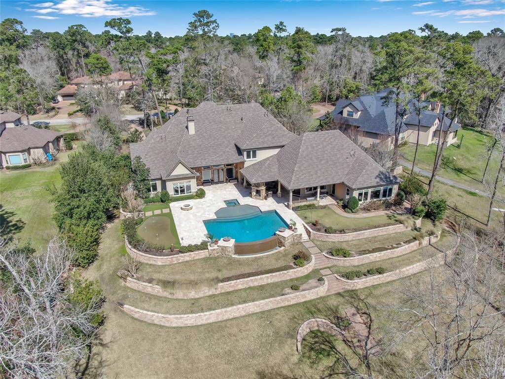 An estate home like no other nestled in the highly desired Woodlands Village of Grogans Point.