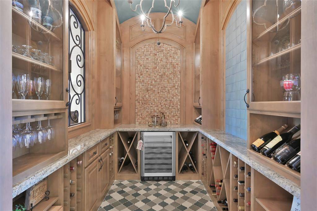Designed for wine-lovers, this wrought iron wine grotto holds more than 100 bottles of cabinet and chilled storage for your collection.