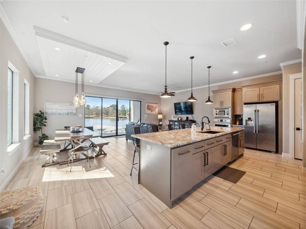 OPEN CONCEPT Expansive living area with Covered Patio for indoor/outdoor living. Beautiful Lake Conroe! Just a short boat ride to the waterpark at Margaritaville.