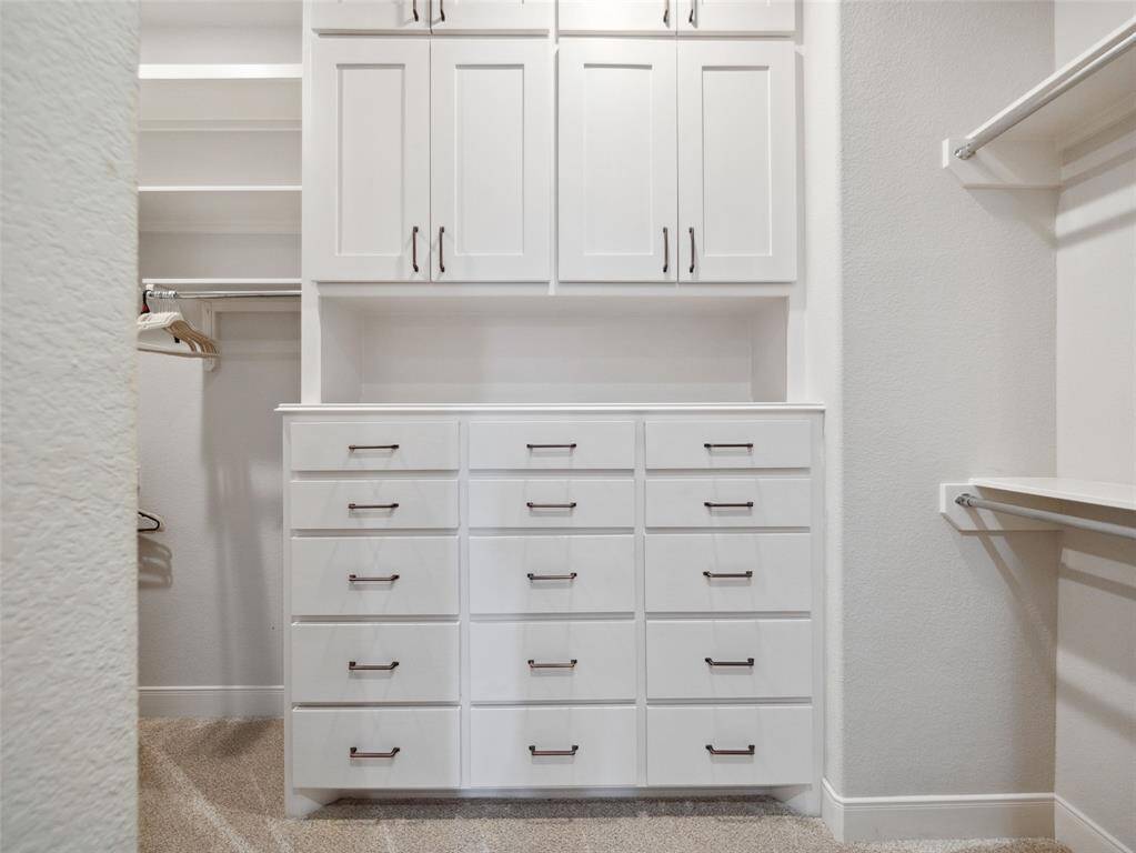 PRIMARY CLOSET  Spacious with great built-ins.