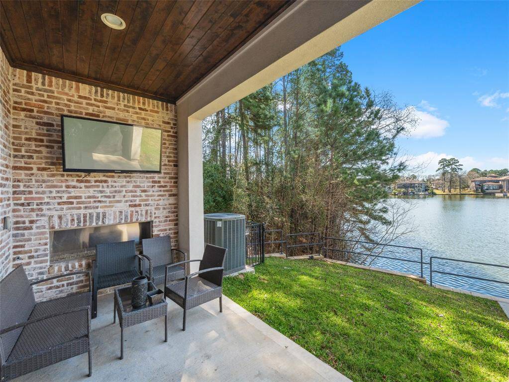 COVED PATIO  With a fireplace & TV, this space expands the living area.