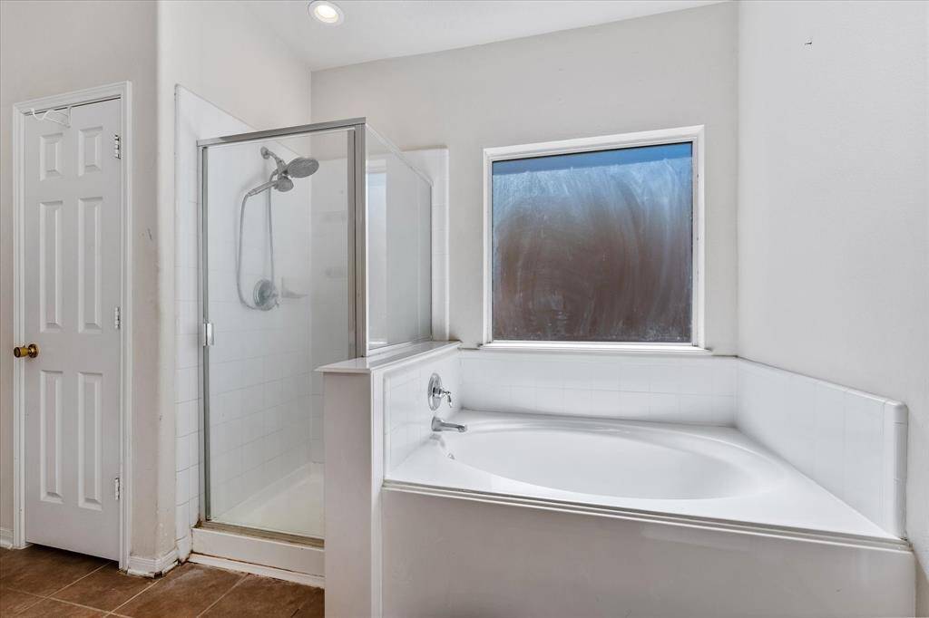 Deep soaking tub and separate shower, rain glsss window for privacy and natural light