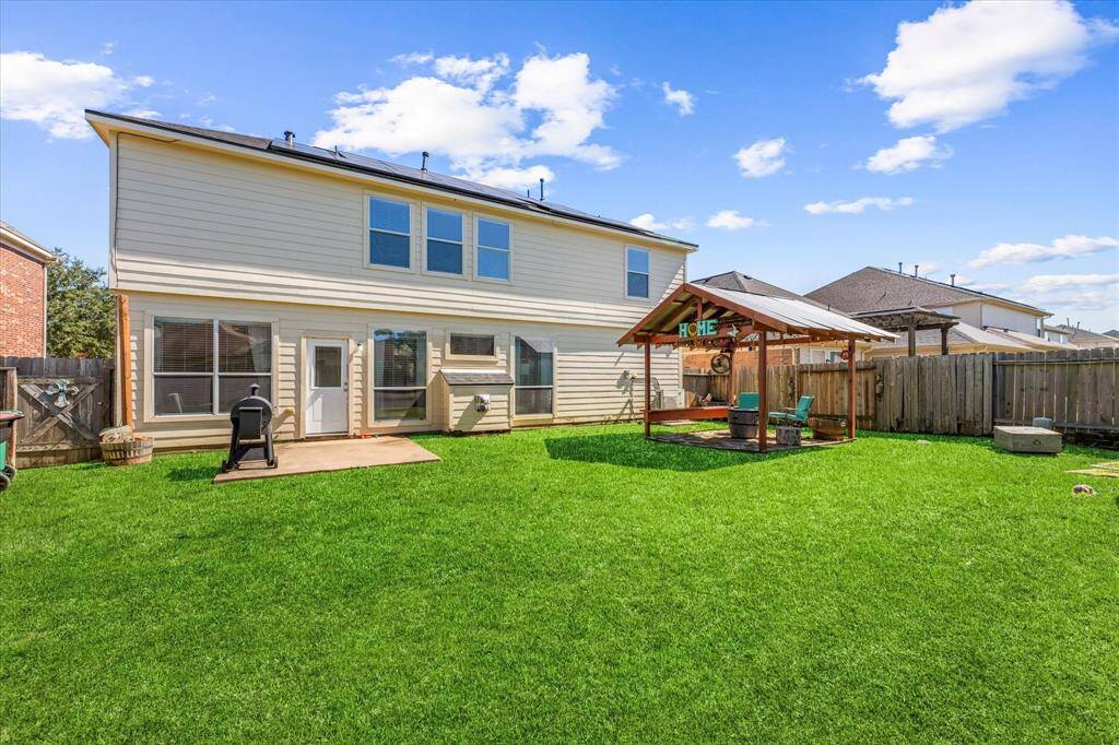Patio for grilling and covered pergola for outdoor dining and entertaining