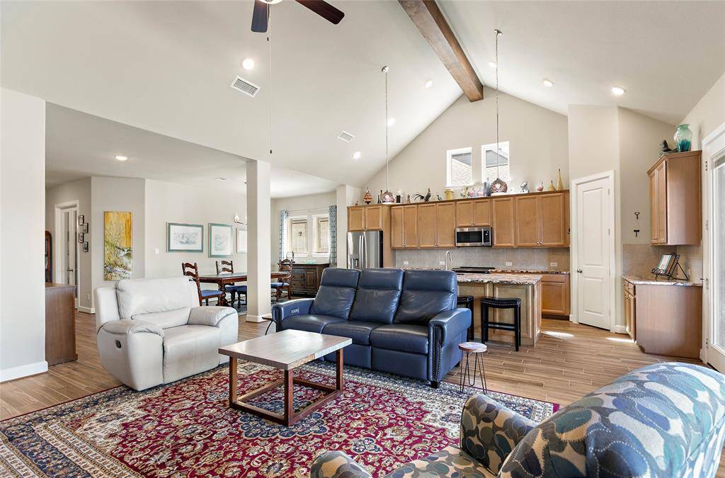 Vaulted ceiling extends from the family room into the island kitchen.