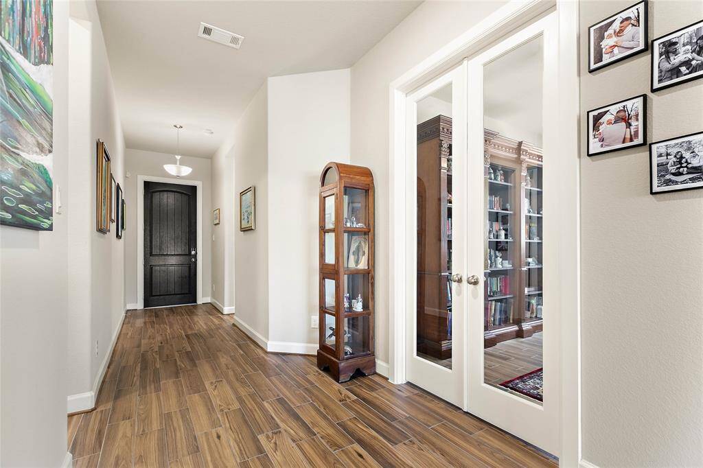 Engaging foyer entry leads to French door that provide privacy for...
