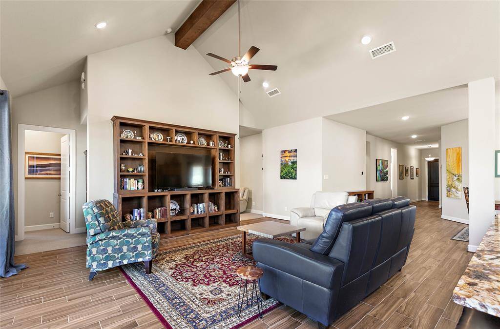 Your family room is accented with vaulted ceilings and exposed beam work giving an open airy feel to the space.