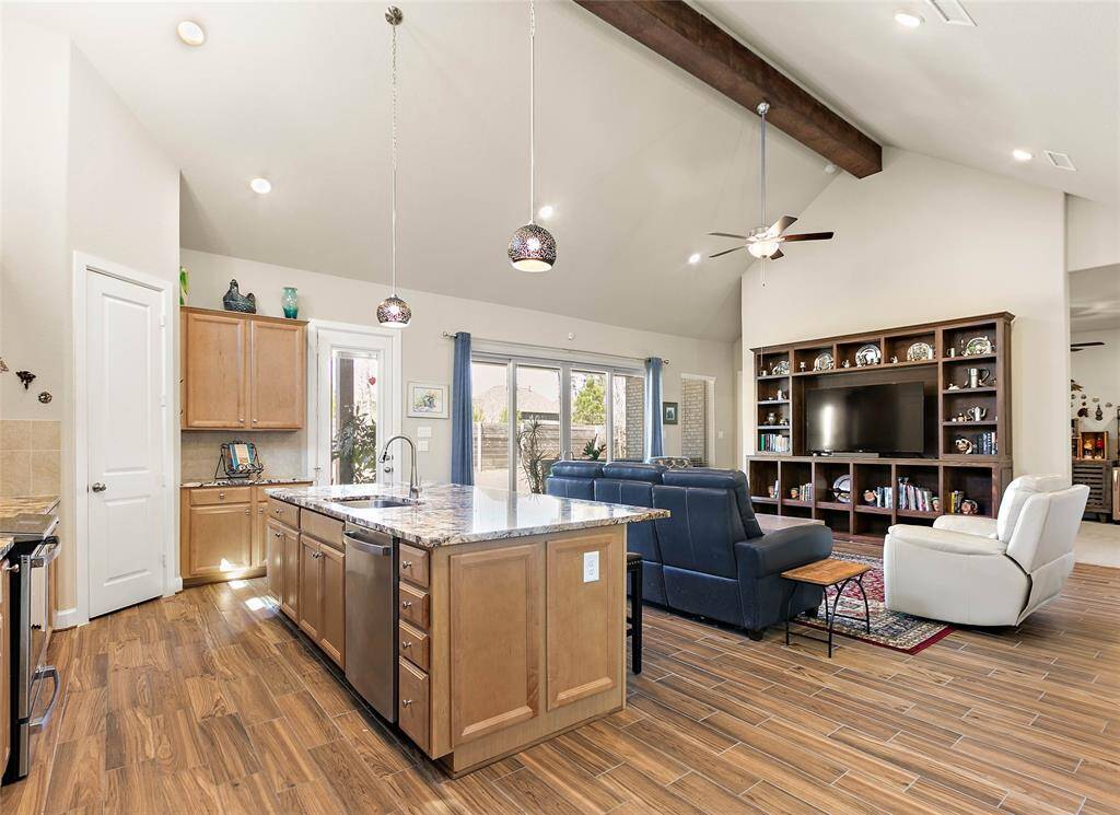 Beautiful, easy care wood-look tile flooring flows through out the living spaces of the home.