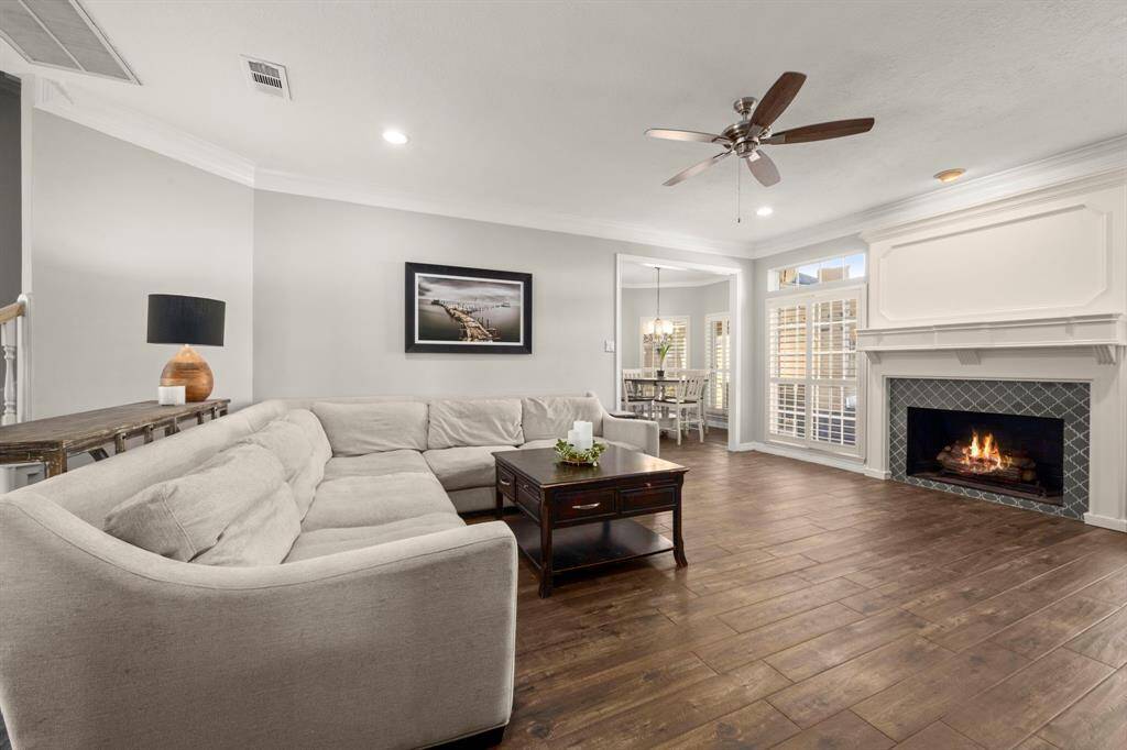 This living space your vibe? Classic style meets modern color palette. Mantel is crisp and gorgeous! And the tile is perfection. This open living room is ready for family movie nights... with just enough privacy in the kitchen to keep the movie night dishes hidden.