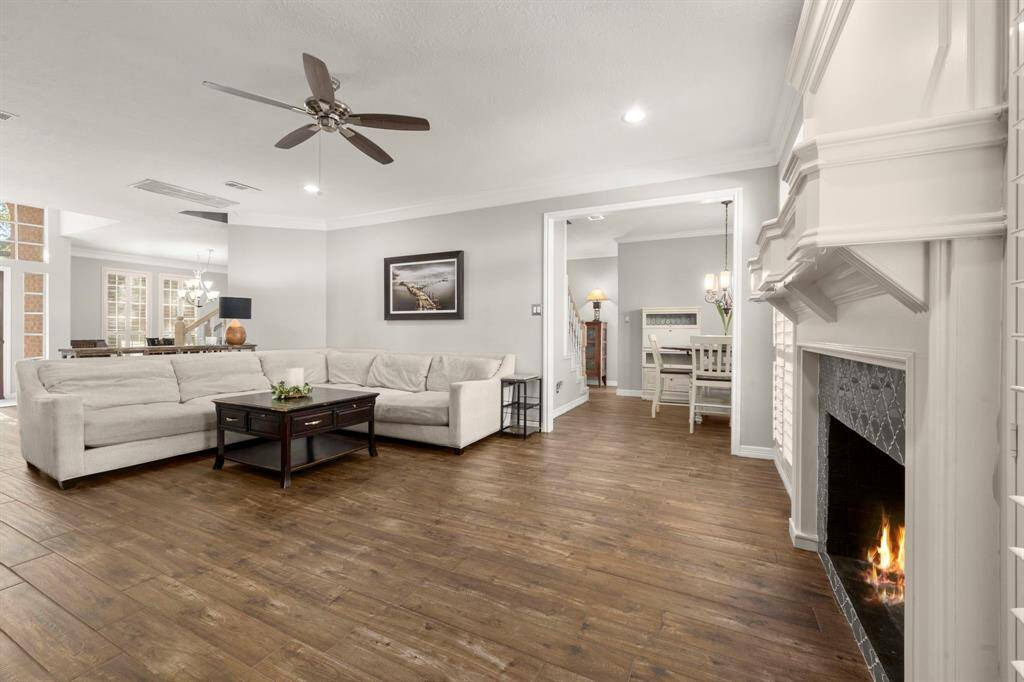 Homeowner added recess cans, new ceiling fan, and a fun tile on the fireplace. Gas logs fireplace will be the focal point for your holiday decor and is flanked by sun-filled windows with shutters.