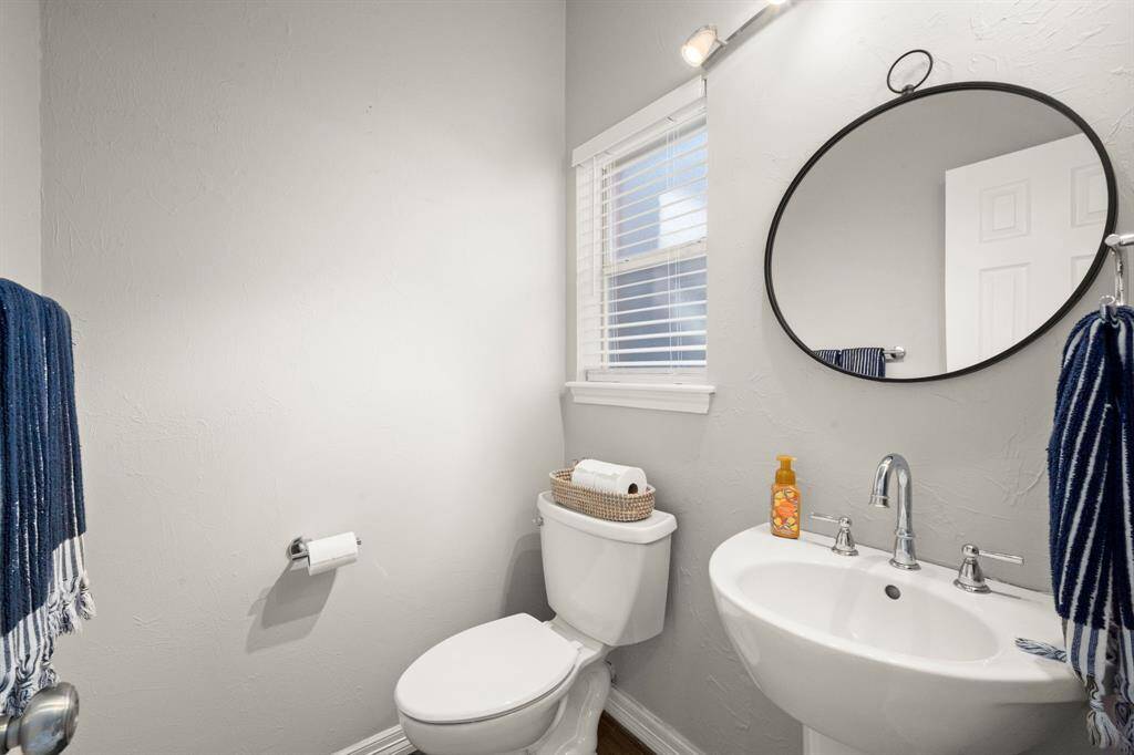 Powder bath is conveniently located near the back yard exit for easy access from the pool area.