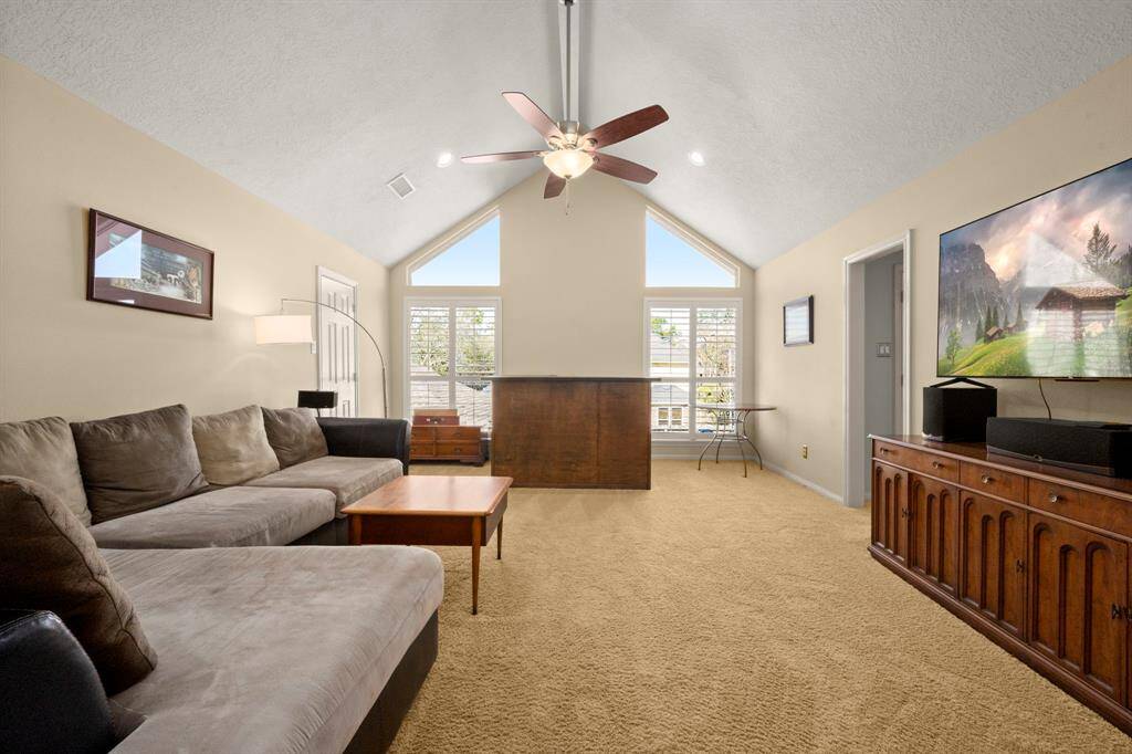 Game room is ready for your movie nights. You'll appreciate the vaulted ceilings and huge storage closet. The hall to the right enters Bathroom 3. Bar is excluded.