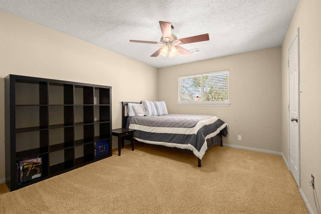 Bedroom 2 - Ceiling fan, neutral paint, walk-in closet, 2" blinds and has an entrance to Bath #2 with a private sink/vanity.