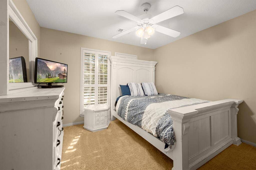 Bedroom 3 - Carpet, shutters, ceiling fan, neutral paint and a walk-in closet. Jack-n-Jill Bath #2 is accessible to this bedroom.