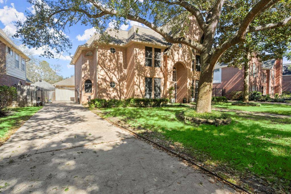 Shade trees and a gated driveway make this home extra special!