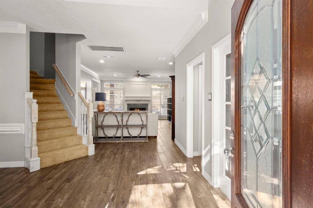 Foyer welcomes guests with neutral paint, white ceilings, crown moldings, a home office to the right and dining room to the left, as you enter.