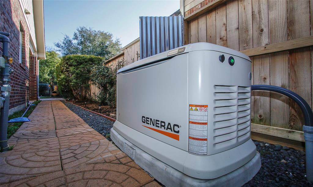 26 KW generator installed in 2024 and stone walkway to patio.