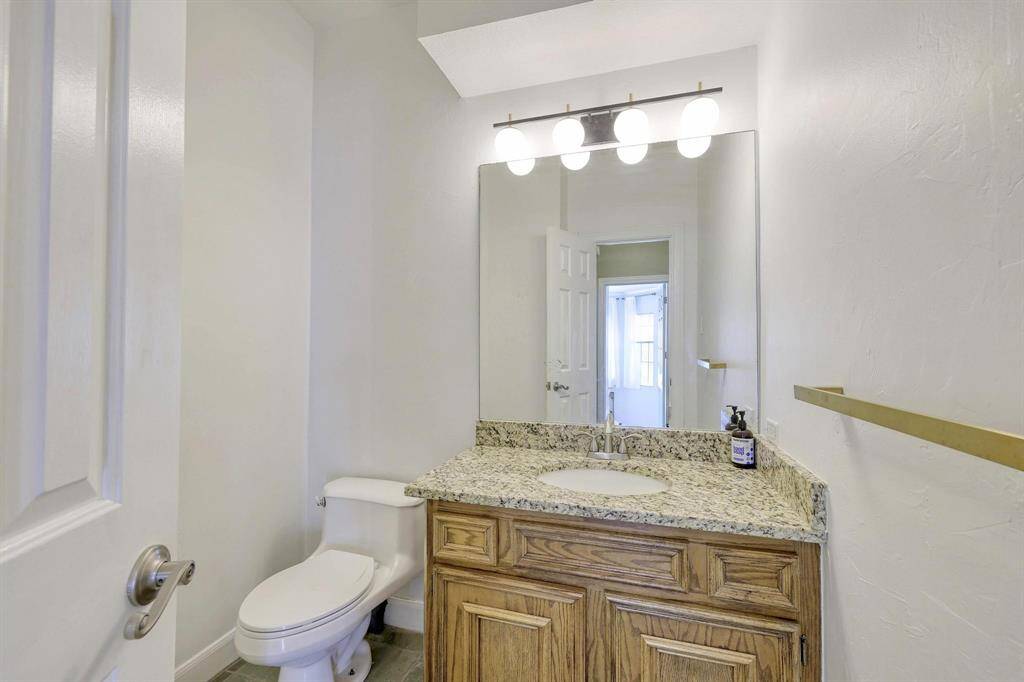 Conveniently located half bath in the downstairs hallway, adjacent to the primary bedroom.