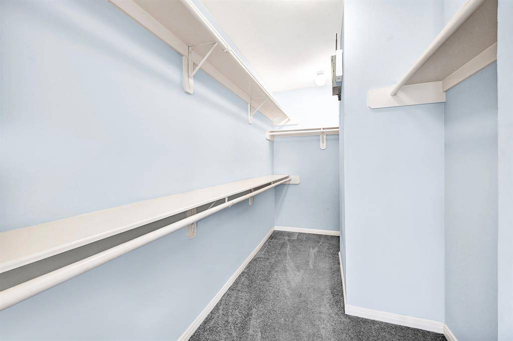 Spacious master closet with ample shelving and hanging space.