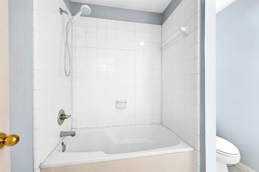 Luxurious master bathroom featuring a pristine white tiled shower and modern fixtures.